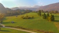 AERIAL: Picturesque drone view of green rural landscape on a sunny evening.