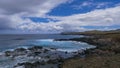 AERIAL: Picturesque view of the blue sky above the coastline of volcanic island. Royalty Free Stock Photo