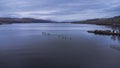 Aerial of a pier on a cloudy day in Loch Lomond, Scotland Royalty Free Stock Photo