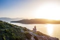 Aerial Poros Greece Dana lighthouse. Sunset backlight. Greek islands on background. Magic golden light photo. Aerial