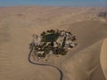 Aerial postcard panorama of Huacachina oasis town village desert dry sand dunes texture pattern Ica Peru South America Royalty Free Stock Photo