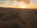 Aerial postcard panorama sunset view of isolated lonely single man person dry sand dunes desert of Huacachina Ica Peru Royalty Free Stock Photo