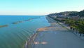 Aerial push-in shot from Cupra Marittima with Adriatic Sea, breakwaters, beach, fisherman, park, promenade