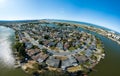 Aerial of residential properties riverside villas yachts alongside curved waterway 35 megapixels