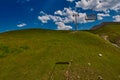 Aerial ropeway high in the mountains of Caucasus with grass plains and cow pastures in the background