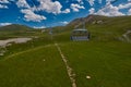 Aerial ropeway high in the mountains of Caucasus with grass plains and cow pastures in the background