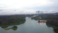 Aerial rotating view of morning fog in Kenyir Lake, Malaysia