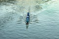 aerial of rower at the river in an five people boat