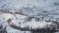 Aerial scenic rural view over Pestera village at the bottom of Piatra-Craiului Mountains during a freezing winter in Romania with Royalty Free Stock Photo