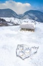 Aerial scenic rural view over Pestera village at the bottom of Piatra-Craiului Mountains during a freezing winter in Romania with Royalty Free Stock Photo