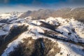 Aerial scenic rural view over Pestera village at the bottom of Piatra-Craiului Mountains during a freezing winter in Romania with Royalty Free Stock Photo