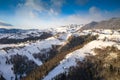 Aerial scenic rural view over Pestera village at the bottom of Piatra-Craiului Mountains during a freezing winter in Romania with Royalty Free Stock Photo