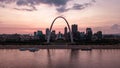 Aerial scenic shot of the Gateway Arch from across the river, downtown Saint Louis skyline at sunset