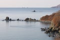 Aerial seascape of Peter The Great Bay in sunny autumn day in sunrise. Calm blue water, rocky capes and islands with lighthouse, s