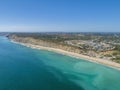 Aerial seascape, of Praia Porto de Mos Beach and seaside cliff formations along coastline of Lagos city, Portugal. Royalty Free Stock Photo