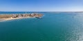 Aerial seascape view of Cape Santa Maria lighthouse island, Praia do Farol beach, one of the barrier islands that protect the Ria