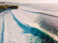 Aerial shooting of big green waves at sunset. Biggest ocean waves in Bali Royalty Free Stock Photo