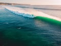 Aerial shooting of big green waves at sunset. Biggest ocean waves in Bali Royalty Free Stock Photo