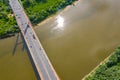 Aerial shooting from flying drone car traffic on modern highway bridge over river Royalty Free Stock Photo