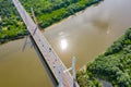 Aerial shooting from flying drone car traffic on modern highway bridge over river Royalty Free Stock Photo