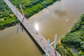 Aerial shooting from flying drone car traffic on modern highway bridge over river Royalty Free Stock Photo