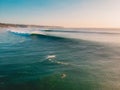 Aerial shooting of waves and surfers at sunset. Biggest ocean waves in Bali Royalty Free Stock Photo