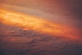 Aerial shot from the airplane window of the sky above the clouds illuminated by sun rays Royalty Free Stock Photo