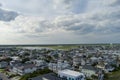 aerial shot along the coast of the Atlantic ocean with beachfront homes, lush green trees with blue sky and clouds Royalty Free Stock Photo