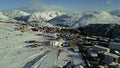 Aerial shot of Alpe d'Huez ski resort on a winter sunny day, high season, France