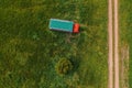 Aerial shot of apiary truck and trailer with beehive boxes in field in spring, drone pov