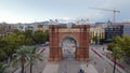 Aerial shot of the Arch of Triumph in Spain surrounded by trees and urban buildings