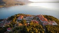 Aerial shot of the archeological site of Plaoshnik and the red roofs of buildings before the sea