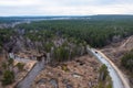 Aerial shot of an asphalt road on green mountain near the river Royalty Free Stock Photo