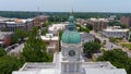 aerial shot of Athens City Hall with a blue dome and clock tower surrounded by buildings, lush green trees and grass and cars Royalty Free Stock Photo