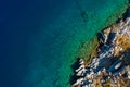 Aerial shot of beach with incredible turquoise colors and rocky cliffs greek island