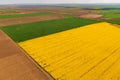 Aerial shot of beautiful cultivated landscape with rapeseed, wheat and corn crop fields Royalty Free Stock Photo