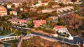 Aerial shot of beautiful mansion homes in Beverly Hills surrounded my palm trees during sunset
