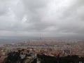 Aerial shot of the beautiful Marseille city in France under the dark cloudy sky Royalty Free Stock Photo