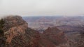 Aerial shot of the beautiful rocks of the Grand Canyon covered in fog in Arizona, USA