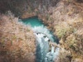 Aerial shot of beautiful Sluncica river wll, hidden deep in the mountain forest with stone cascades in the river stream