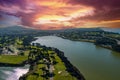 aerial shot of a beautiful spring landscape at Lake Merced with blue lake water and lush green trees, grass and plants at sunset Royalty Free Stock Photo