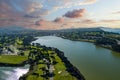 aerial shot of a beautiful spring landscape at Lake Merced with blue lake water and lush green trees, grass and plants at sunset Royalty Free Stock Photo