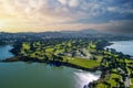 aerial shot of a beautiful spring landscape at Lake Merced with blue lake water and lush green trees, grass and plants at sunset Royalty Free Stock Photo