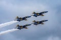 Aerial shot of the Blue Angels aircrafts in blue and yellow colors performing an air show Royalty Free Stock Photo