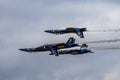 Aerial shot of the Blue Angels formation performing an air show before the clouds Royalty Free Stock Photo