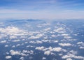Aerial shot of blue sky with clouds and mountain view from plane Royalty Free Stock Photo