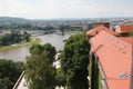 Aerial shot of boats on Vistula river in Krakow, Poland with historical buildings in the background