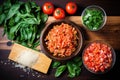 aerial shot of brushed bread, fresh basil, crushed garlic, and finely diced tomatoes
