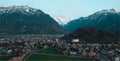 An aerial shot of buildings surrounded by mountains