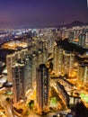 Aerial shot of bustling skyscrapers of Hong Kong at night.